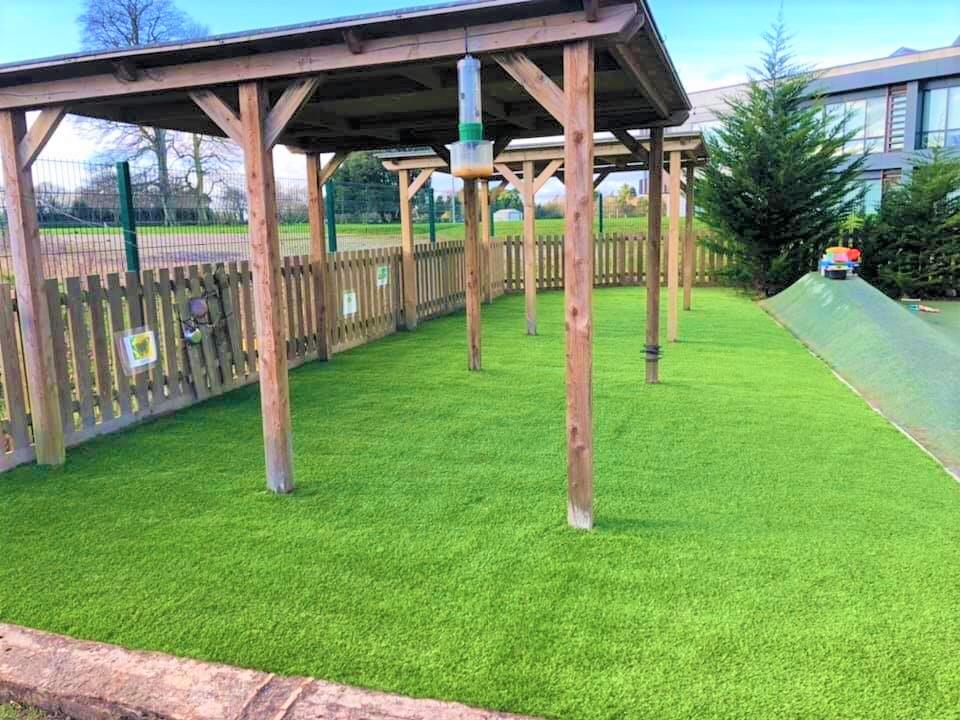 outside space at a nursery with canopy and grass
