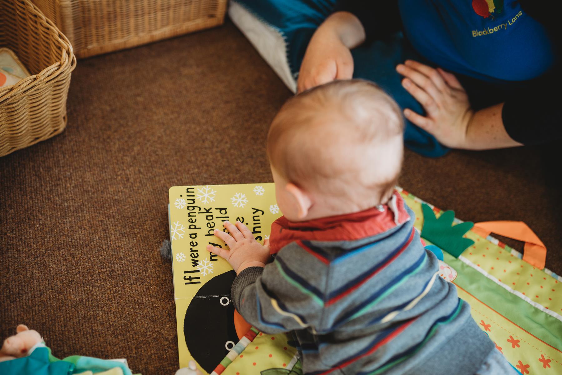 baby learning to crawl - on top of book